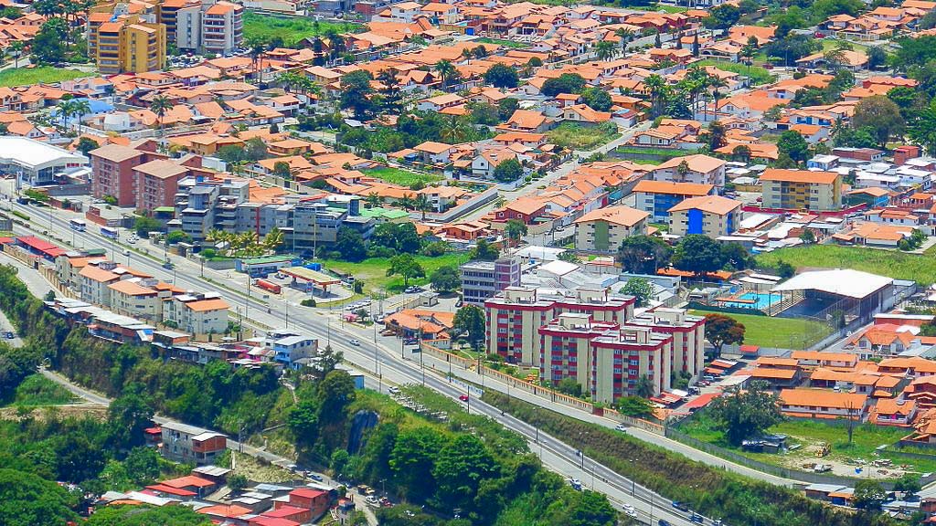 A large town. The buildings have red/brown roofs. 