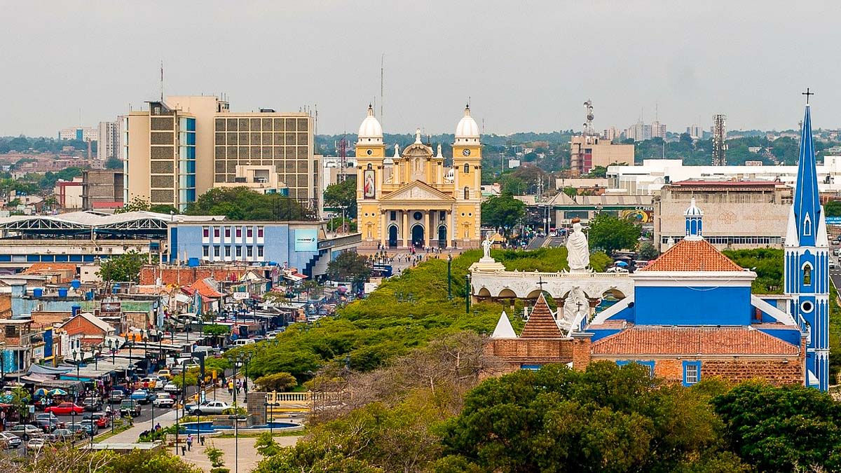 a cityscape. There is a yellow cathedral in the centre of the image.