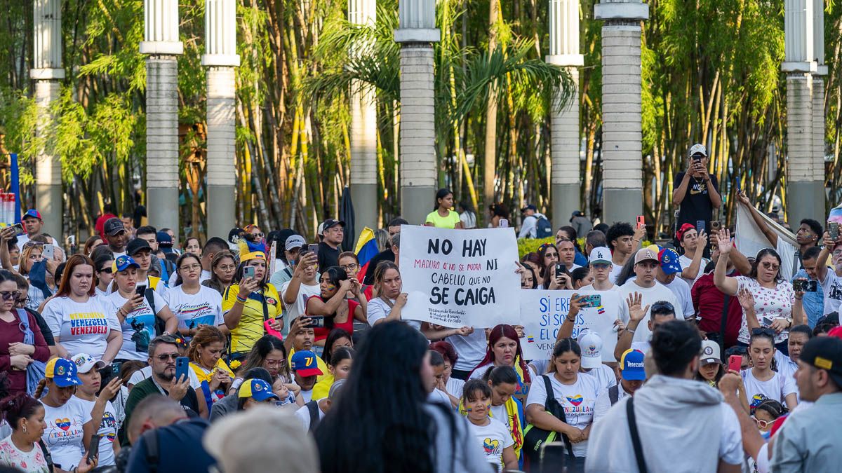 A woman holds a sign at a protest.