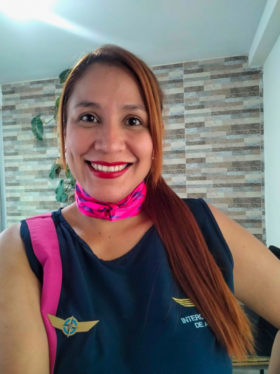 A woman wearing a flight attendant uniform.