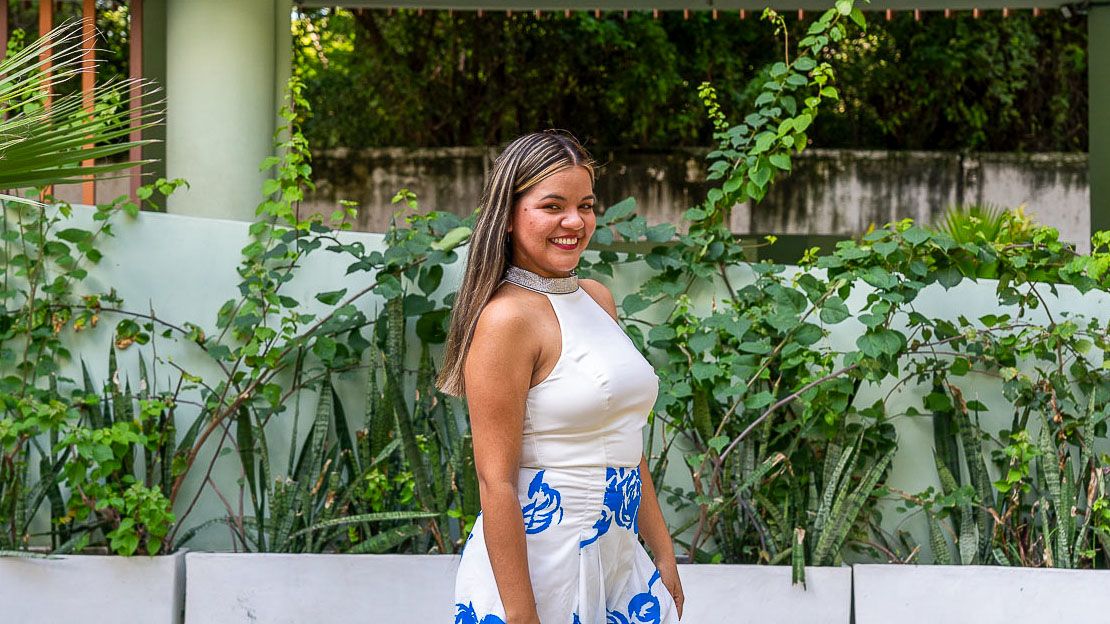 A young woman smiles at the camera.