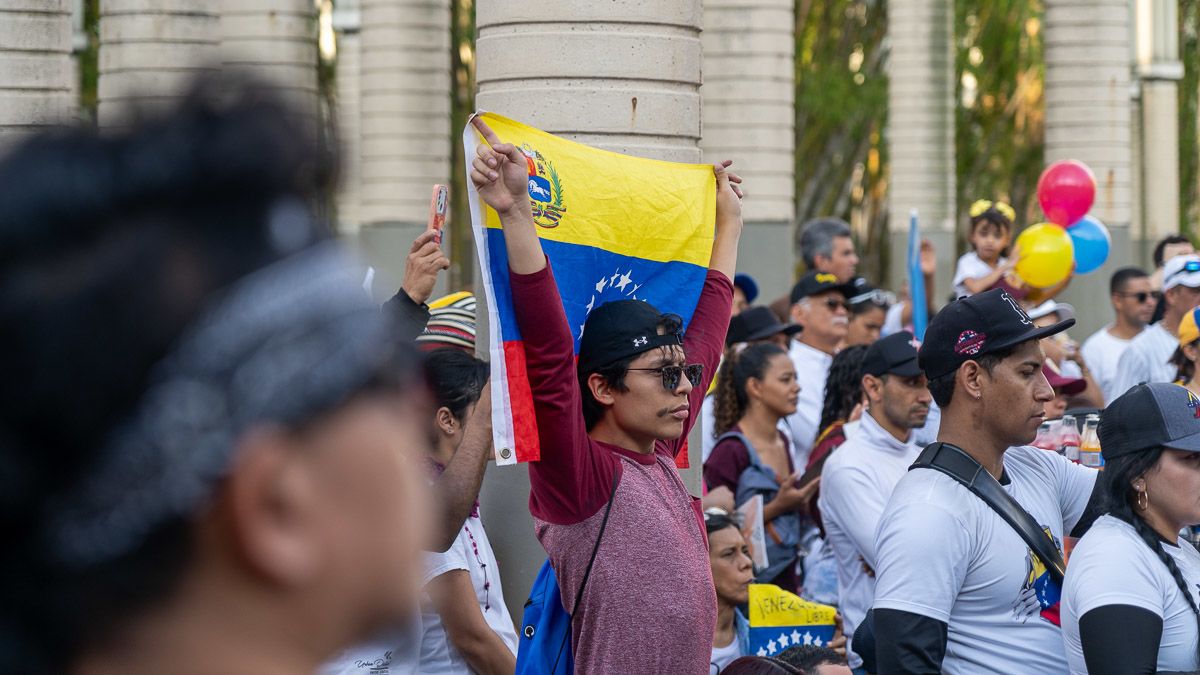 A man waves a Venezuelan flag at a rally.